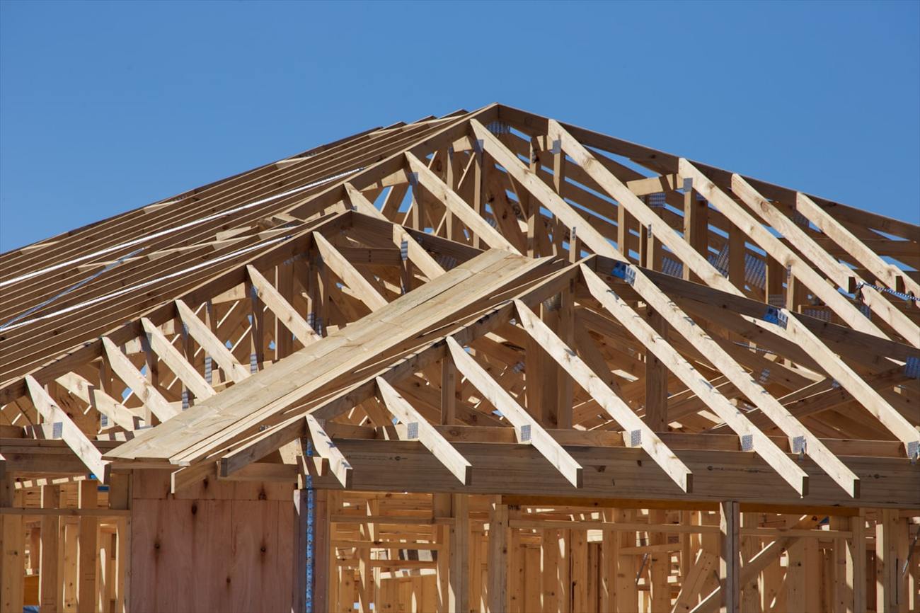 Prefabricated timber roof trusses installed on a new house frame.