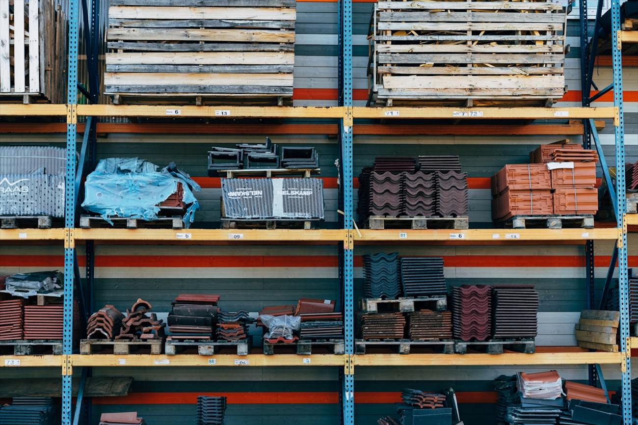 Racked building supplies including roof tiles and fittings in a trade warehouse.